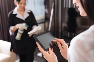 A tablet is being used by hotel housekeeping staff