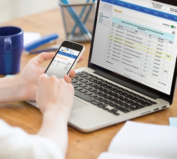 KeyTracer key management system dashboard data being analyzed by an employee using a smart phone