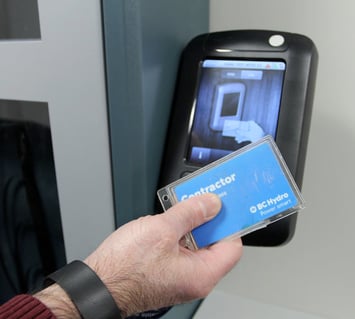An employee using an access card to access hotel devices