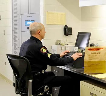 A law enforcement officer uses a smart locker to manage evidence properly