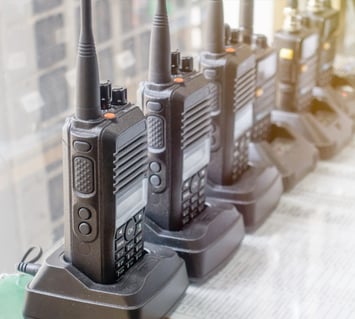 Management of two-way radios with an equipment management system