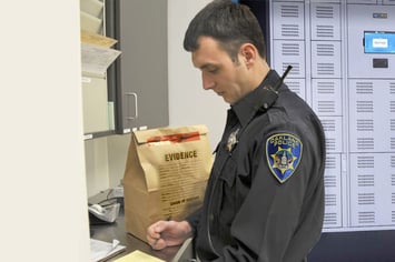 An evidence management system is used by a police officer in law enforcement