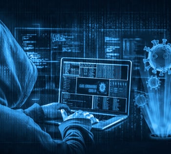 Cyber criminal using a computer for a cyber attack.