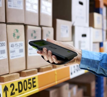 Handheld scanner used in a warehouse by an employee