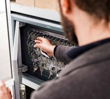 Physical keys are managed using an electronic smart key cabinet by an employee.
