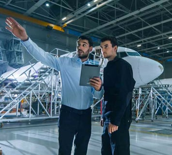 Aircraft Maintenance Manager and Aircraft Maintenance Engineer inspecting repair needs in a hangar