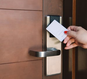 Accessing a hotel room with an RFID card by a woman