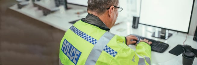 A police officer using a smart asset management system to control assets and armory