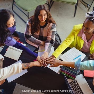 A diverse group of professionals collaborating in a modern office setting, symbolizing teamwork in establishing a cybersecurity culture.