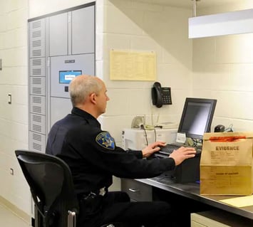 Police Officer Using a Smart Locker to Store Evidence