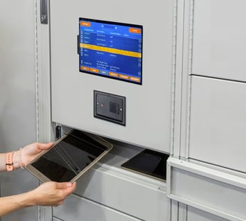 College student putting a tablet back in a smart locker