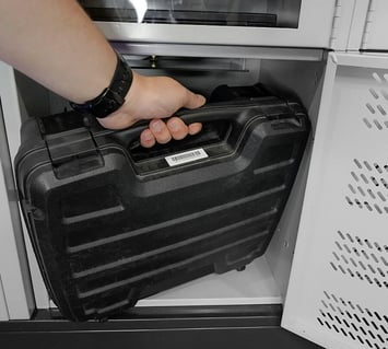 Police equipment is stored in a smart locker by a police officer