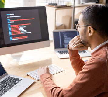 Man in front of a computer analyzing data