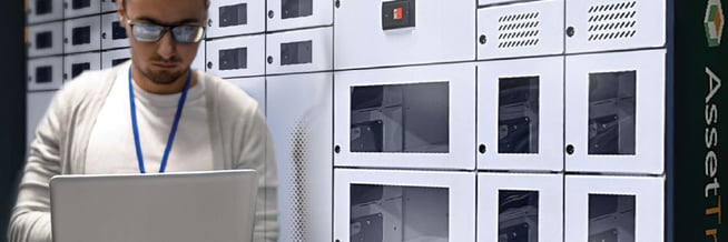 An employee using a smart locker system to store a laptop