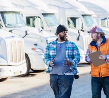 A fleet manager discusses fleet usability with a truck driver