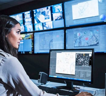 A police analyst looking at traffic cameras