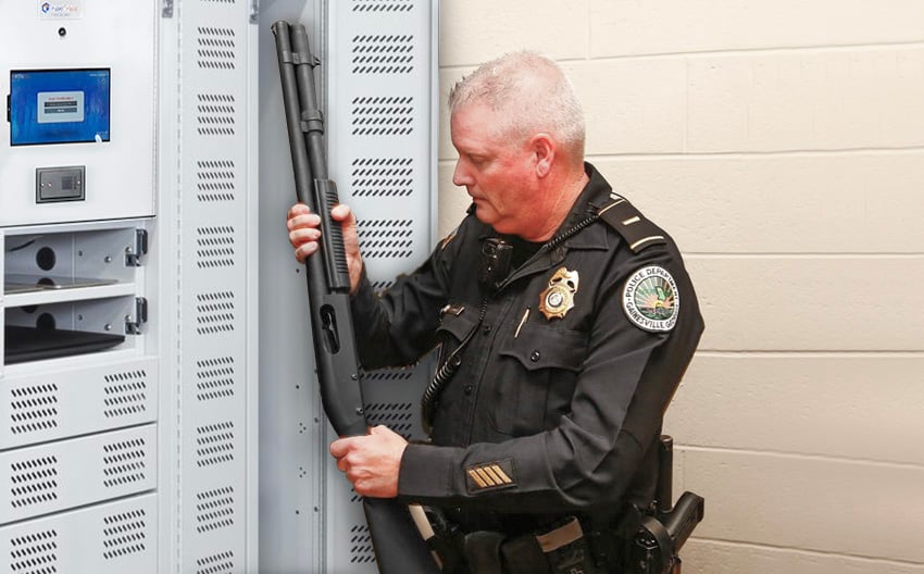 Police Officer Using an AssetTracer Smart Locker to Store a Long Rifle