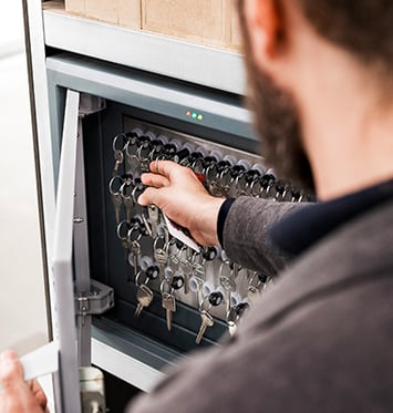 Man Taking a Key Out of a Smart Key Cabinet