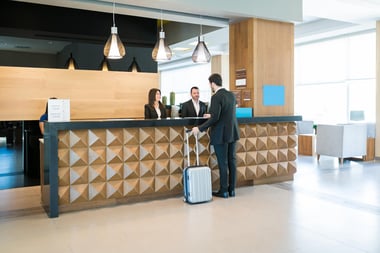 Man checking in at the hotel's front desk