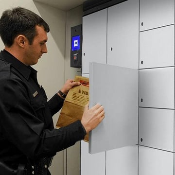 Police officer depositing a sealed evidence bag into a smart evidence locker that time-stamps the transaction automatically