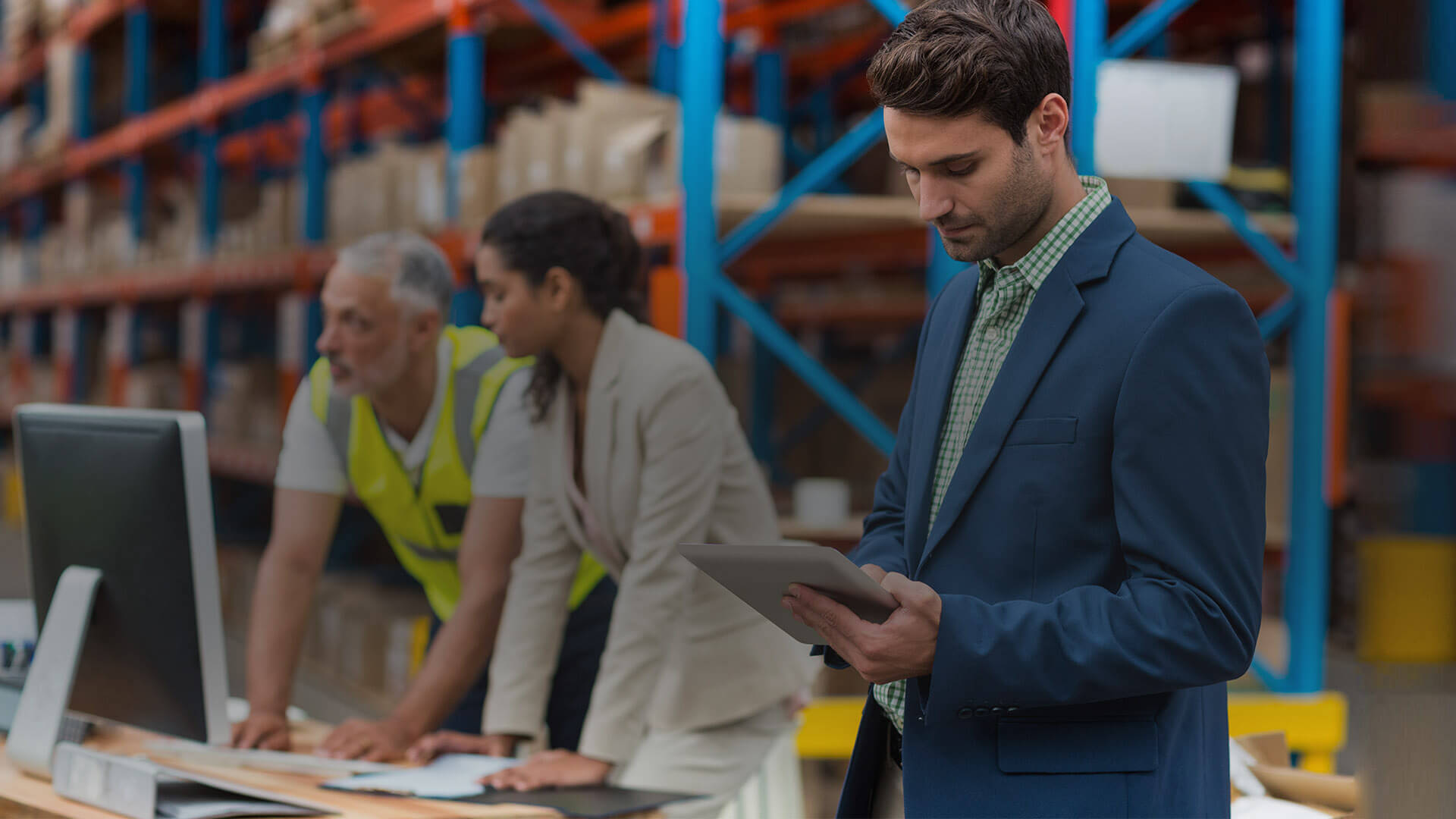 Man Using a Tablet to Manage Warehouse and Logistics Equipment Management