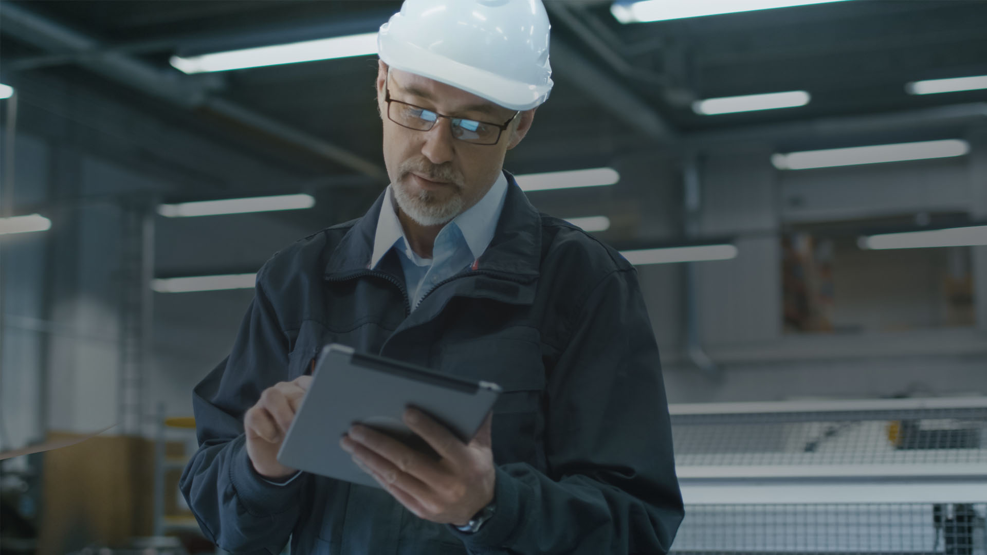 A man in a helmet oversees the production process