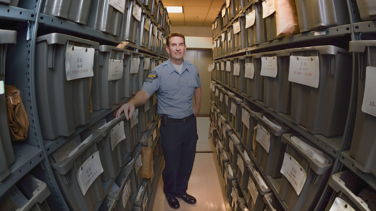 An police officer standing in an evidence room