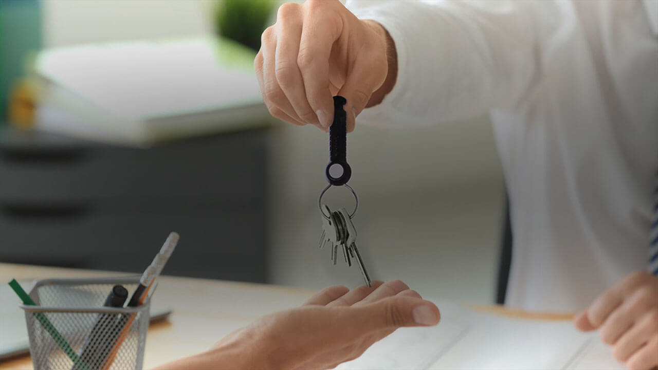 Employee holding an indestructible key fob