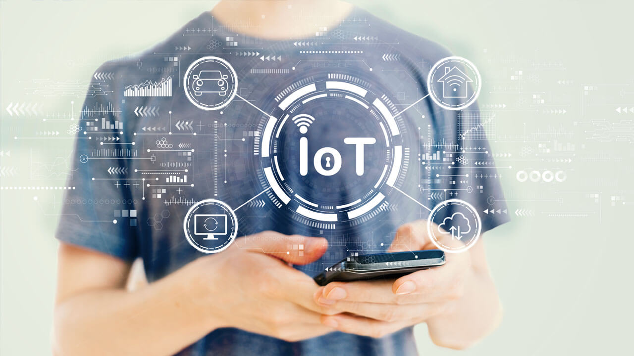 An employee monitors the security of the IoT network using an IoT security solution