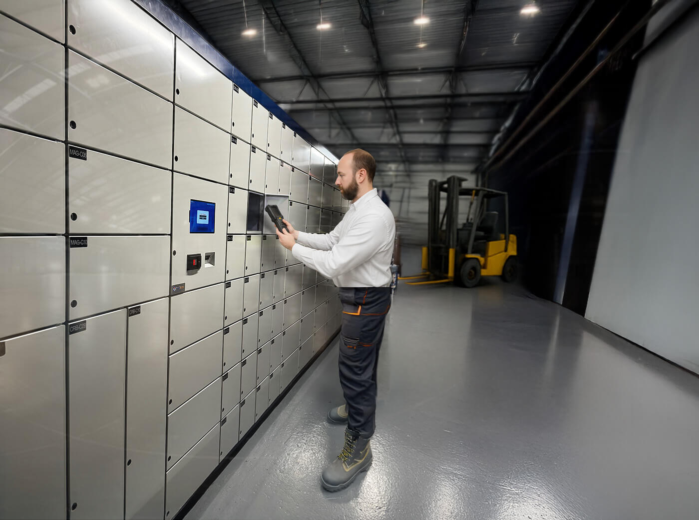 Warehouse employee using intelligent locker system for secure tool storage and equipment tracking
